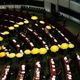 Pro-democracy lawmakers carrying yellow umbrellas, symbols for the Occupy Central movement, leave in the middle of a Legislative Council meeting as a gesture to boycott the government in Hong Kong